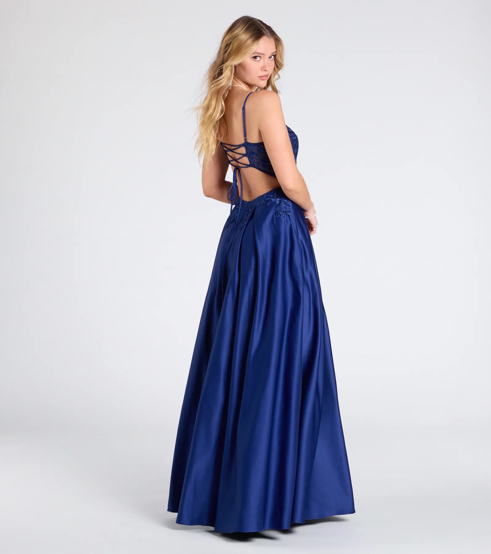 Step into the Prom 2025 dance in the Myra Lace-Up Floral Embroidered A-Line Ball Gown in navy, a stunning blue prom dress designed to complement any theme with its timeless allure and statement-making style.