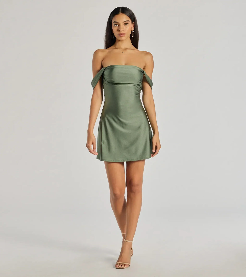 Make a bold statement in the Classics Lover Off-The-Shoulder Satin A-Line Mini Dress in sage green, the perfect green dress for weddings, cocktail hours, nights out, and/or seasonal celebrations.