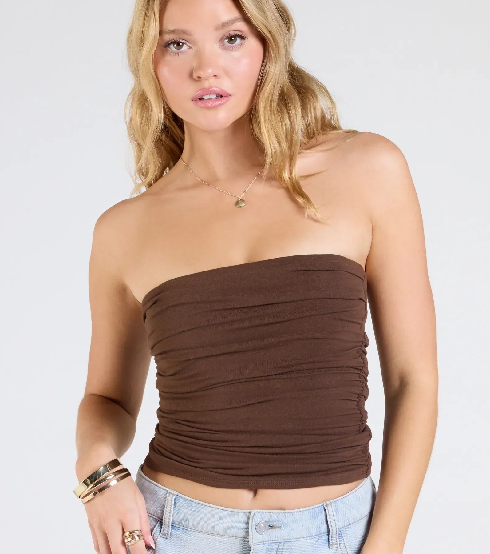 Trendy women’s tops, like the Cutest Vibe Ruched Knit Tube Top, bring effortless style for fall layering, lounging, or going out.