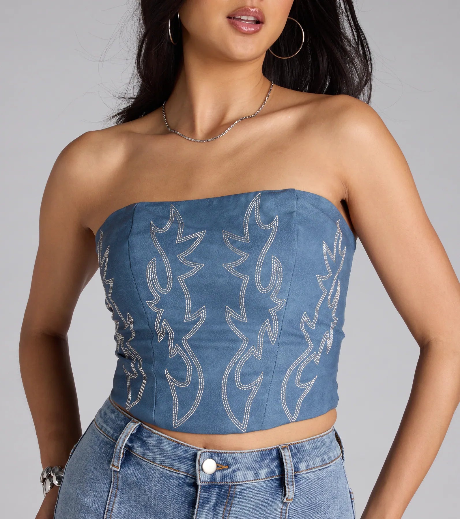 For college campus looks, game day outfits, or a bold going-out vibe, the Major Hottie Lace-Up Flame Tube Top is an on-trend denim blue crop top that easily styles with your favorite denim.