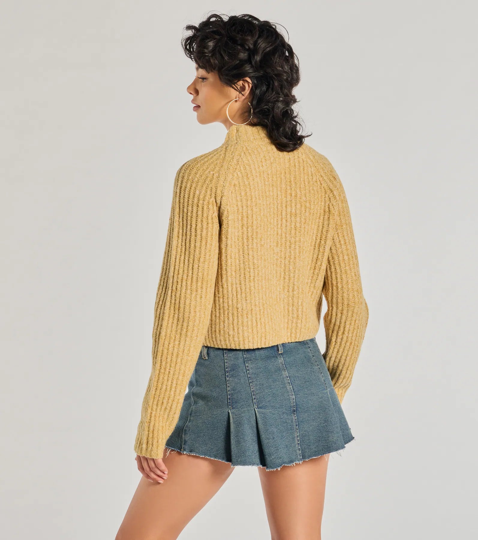 With its midriff cut and trend-forward fit, the Stylishly Casual Mock Neck Knit Sweater is a mustard yellow crop top made to pair with skirts, denim, or whatever vibe you're feeling this season.