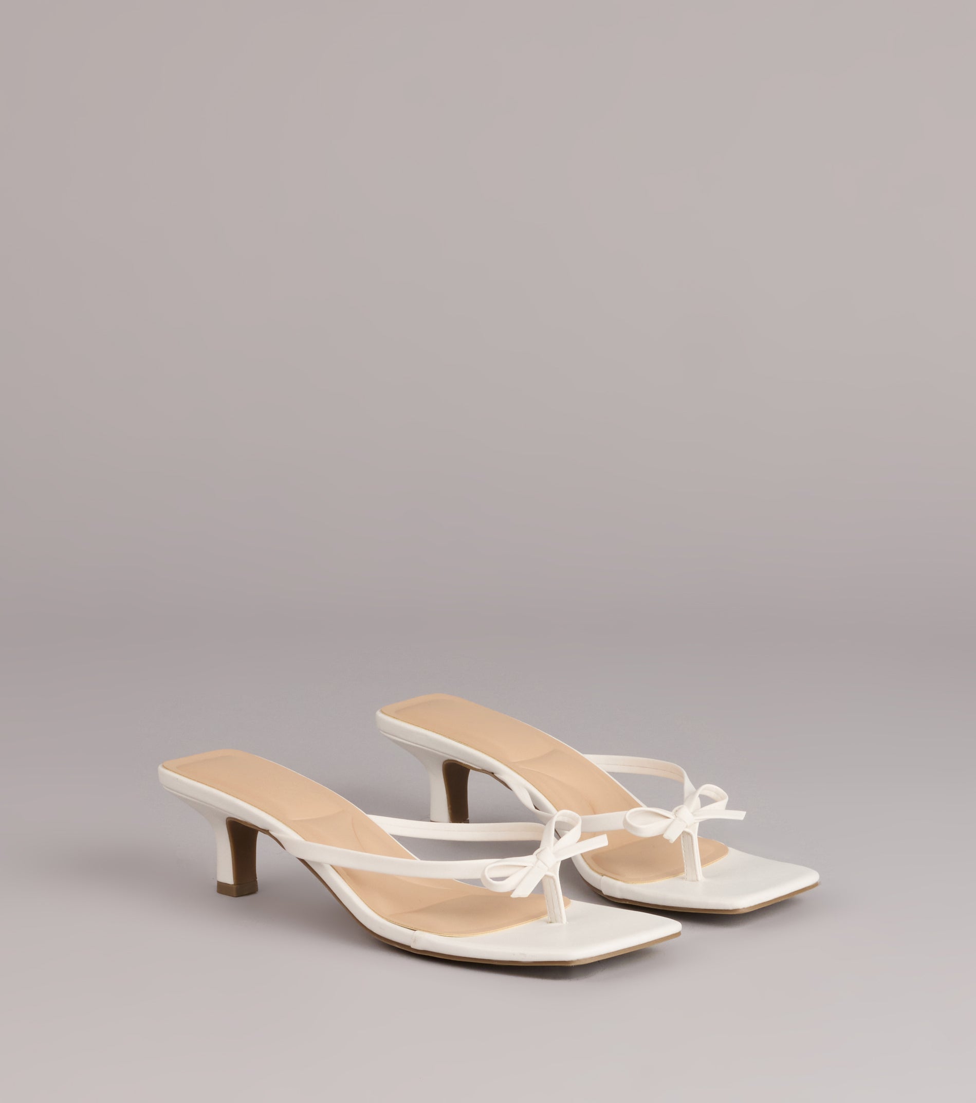 Style made simple with the Play Nice Bow Thong Heels, trendy women’s shoes that take your outfit from basic to bold in one step.